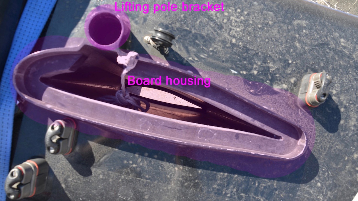 THE CURRENT AC45 CLASS RULE ONLY ALLOWS THE DAGGERBOARDS TO MOVE UP AND DOWN. THIS CLOSEUP SHOWS THE STANDARD DAGGERBOARD HOUSING. NOTE, TOO, THE LOCATION OF THE FITTING FOR THE LIFTING POLE.