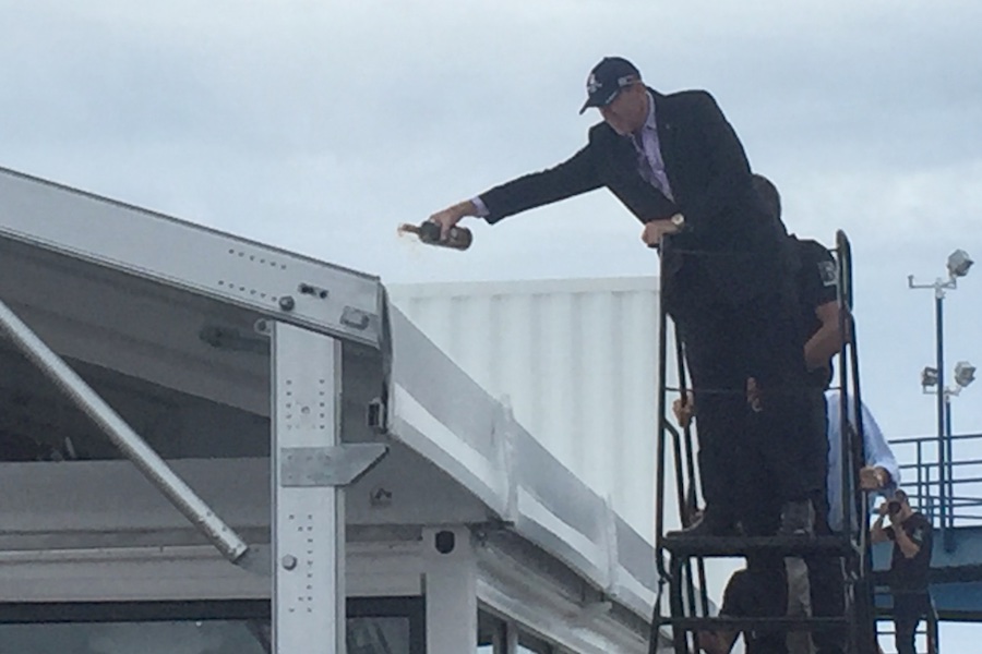 After toasting the new base with sake, Premier Michael Dunkley performs the ceremonial roof wetting with Gosling's Black Seal Rum... 