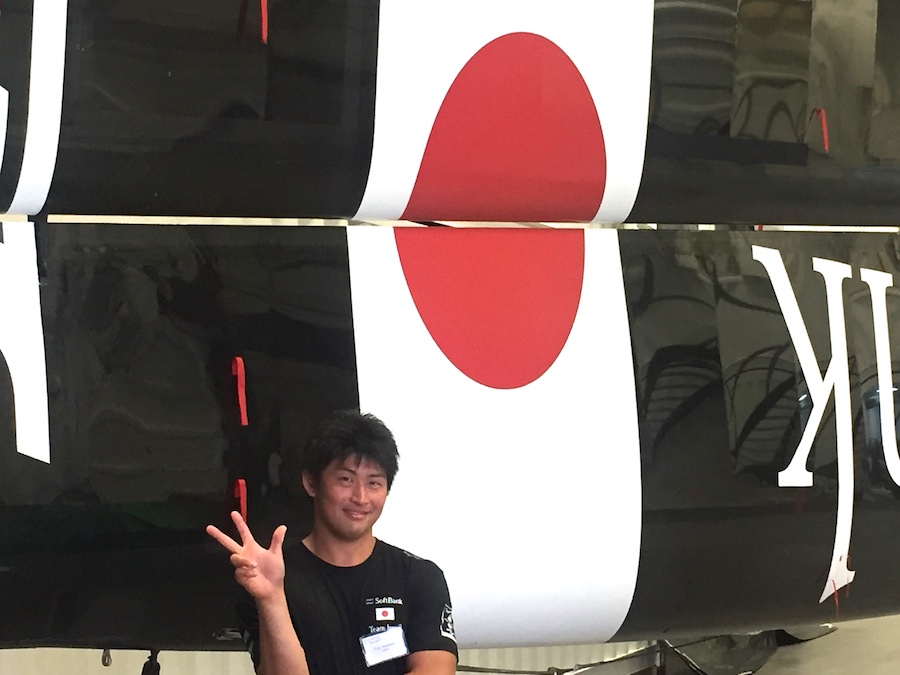 Team Japan grinder Yuki Kasatani in the boat shed with the wing from their experimental AC45X. Yuki is an elite oarsman, recruited to join the other "muscle and stamina" teammates.