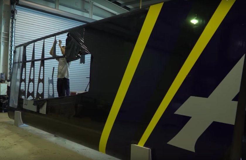 America's Cup challenger Artemis Racing repairing wing for their America's Cup Class race boat. It was damaged when the test boat on which the wing was installed broke up.