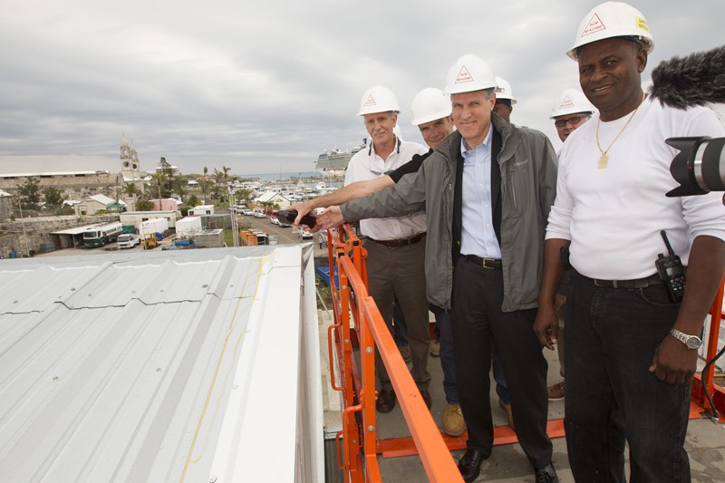 America's Cup The two Grants - Grant Gibbons, Bermuda Minister of Economic Development and Grant Simmer, Oracle Team USA General Manager - perform the roof wetting ceremony at the team's new base in Dockyard. Photo: JP Roujas